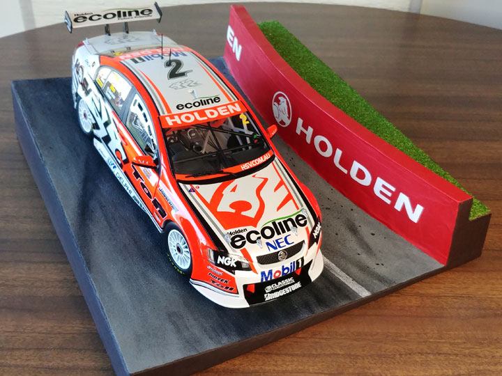 A Holden Racing Team model V8 Supercar on a Bathurst diorama