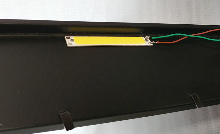 A LED light panel fixed to the top of the frame